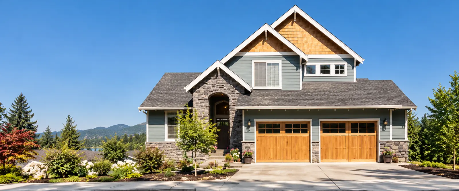 Character-style West Side home with a three-bay garage fitted with warm natural-wood carriage doors under a clear blue sky